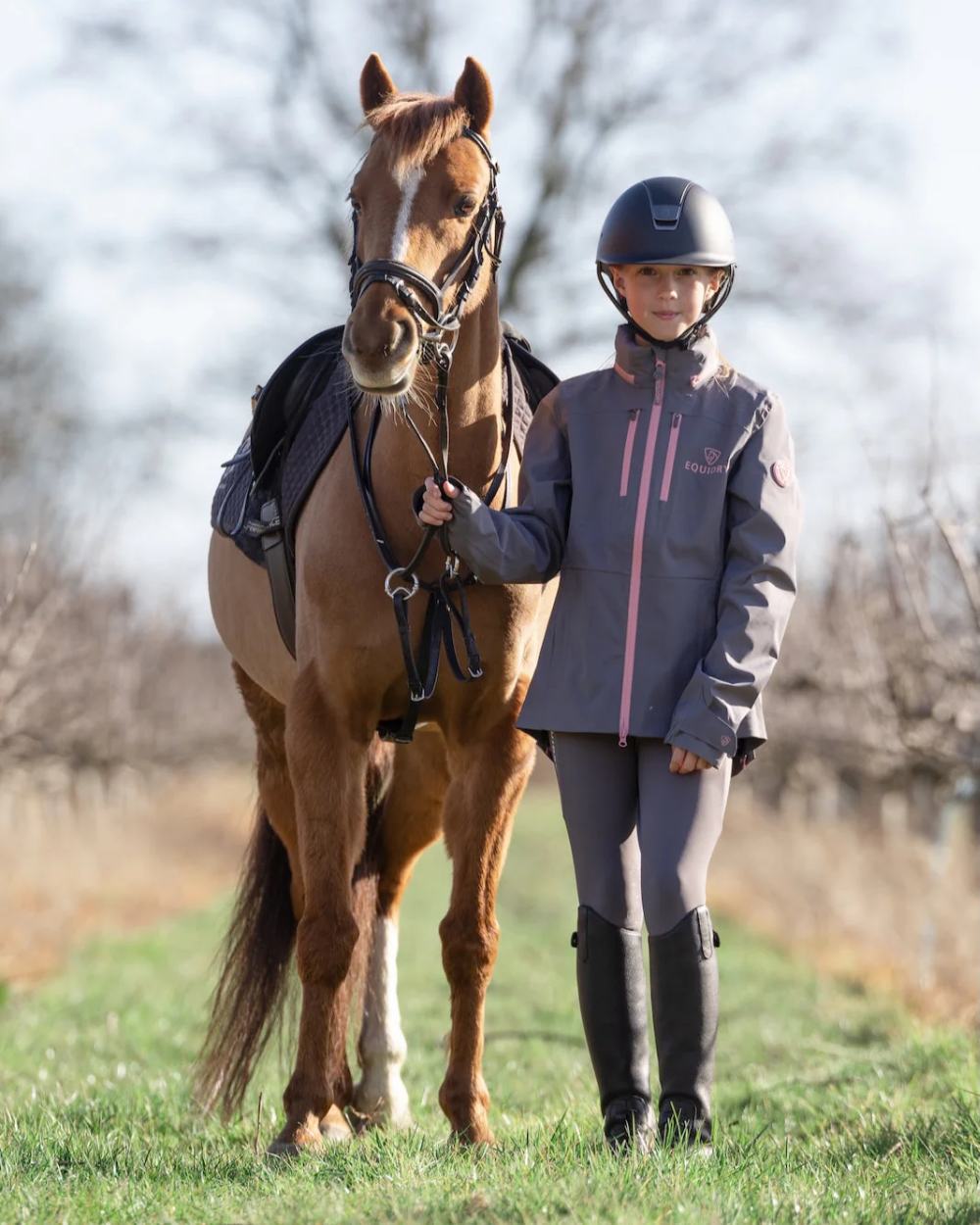 Charcoal Pink Equidry Childrens Varsha Waterproof Jacket on yard background 