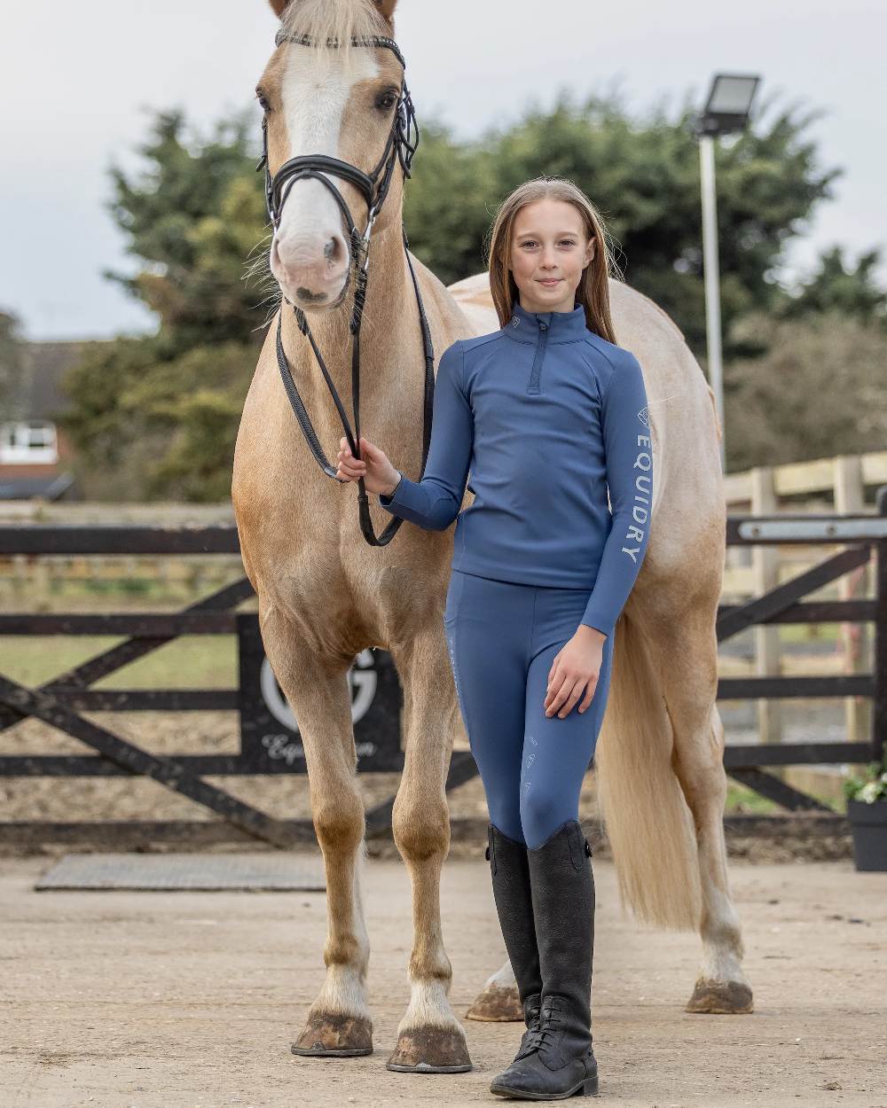 Steel Blue Grey Coloured Equidry Childrens Water Repellent Base Layer on outdoor background 