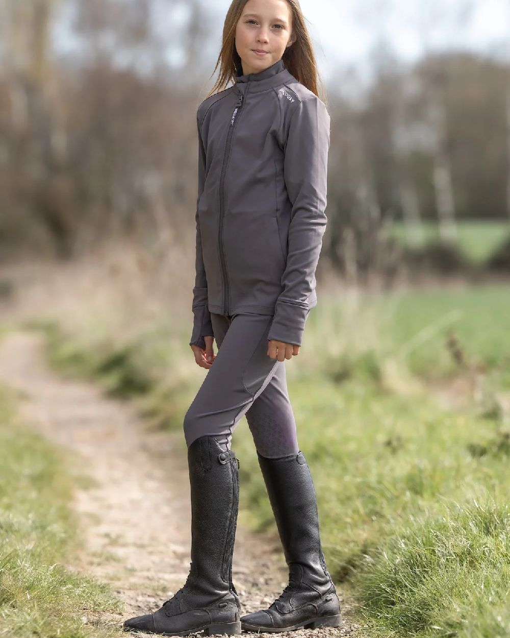 Grey White Coloured Equidry Childrens Water Repellent Knee Grip Leggings on outdoor background 