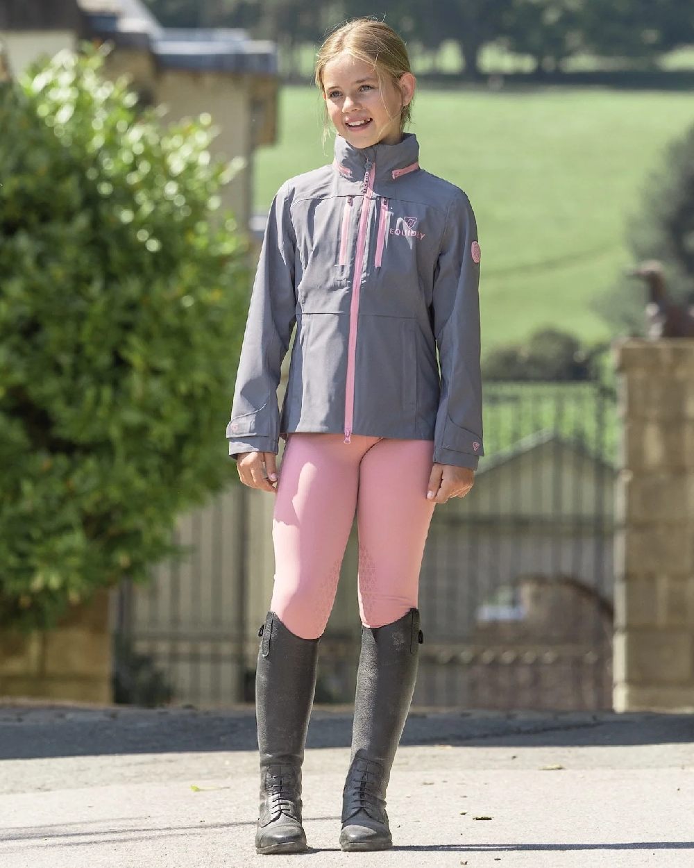 Pale Pink Grey Coloured Equidry Childrens Water Repellent Knee Grip Leggings on outdoor background 