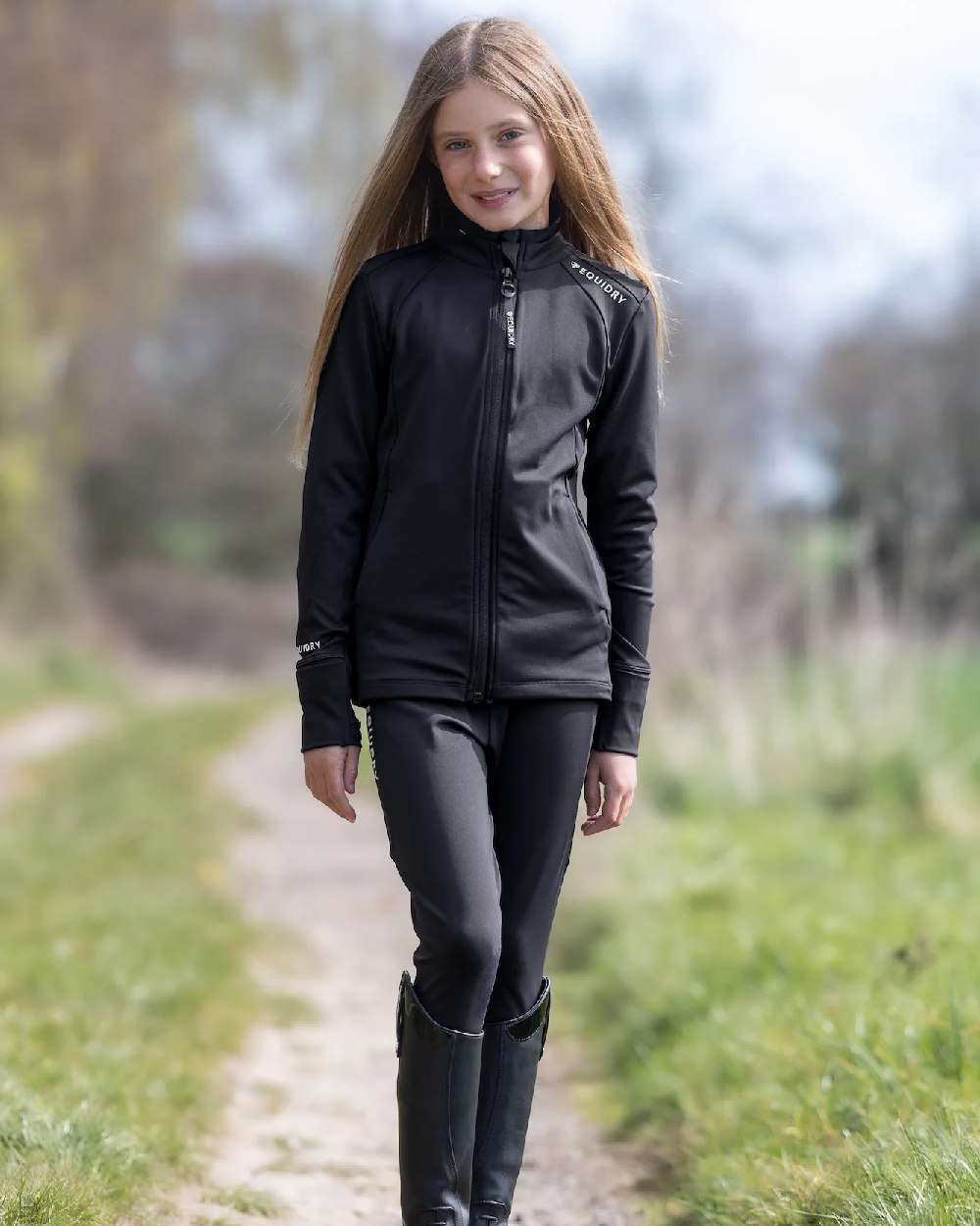 Black White Coloured Equidry Childrens Water Repellent Zip Up Top on outdoor background 