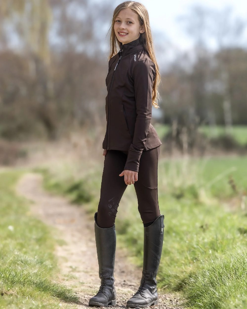Brown White Coloured Equidry Childrens Water Repellent Zip Up Top on outdoor background 
