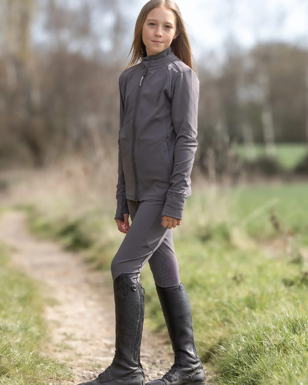 Grey White Coloured Equidry Childrens Water Repellent Zip Up Top on outdoor background 