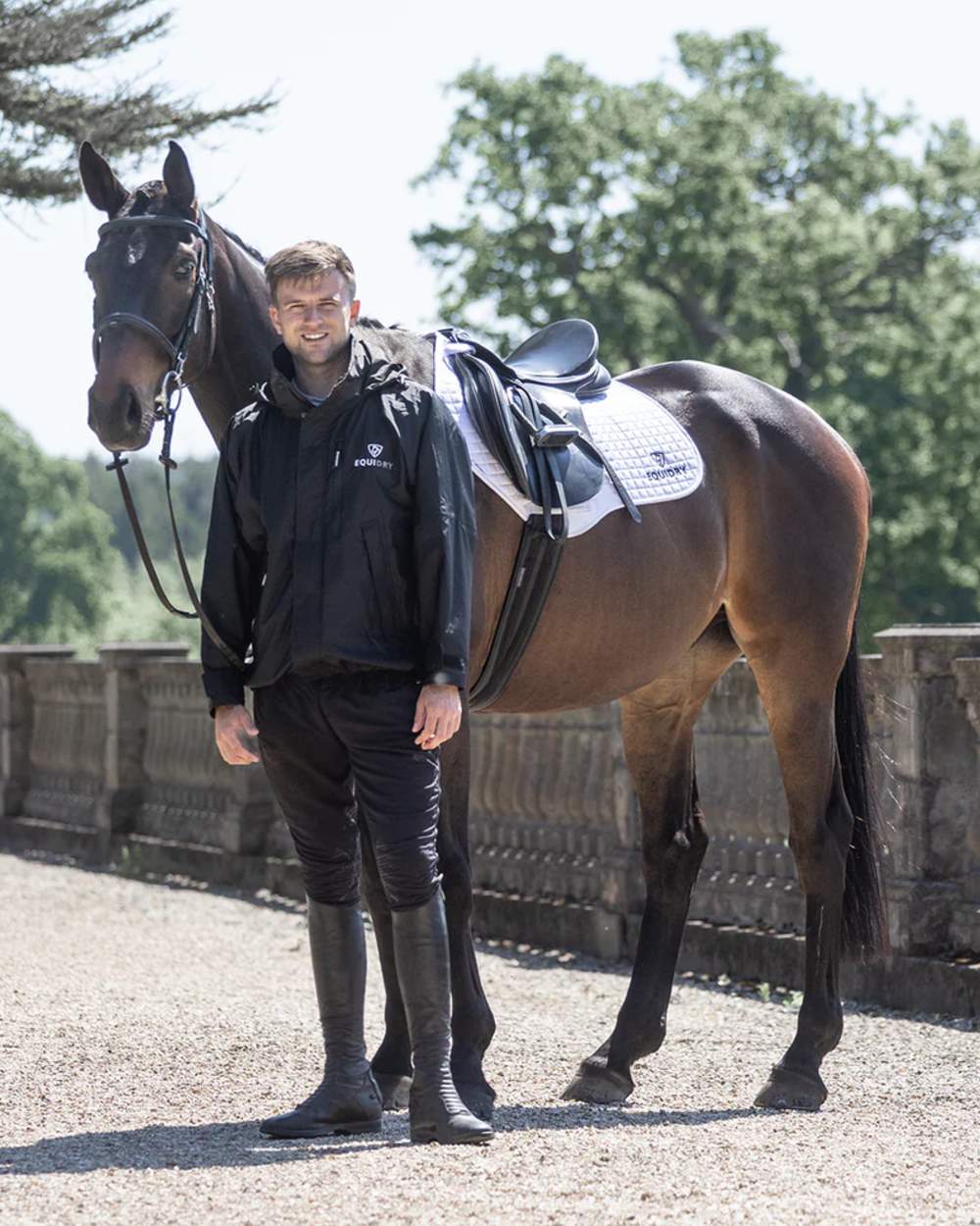 Black coloured Equidry Mens Equimac Shortie With Stowaway Hood on outdoor background 