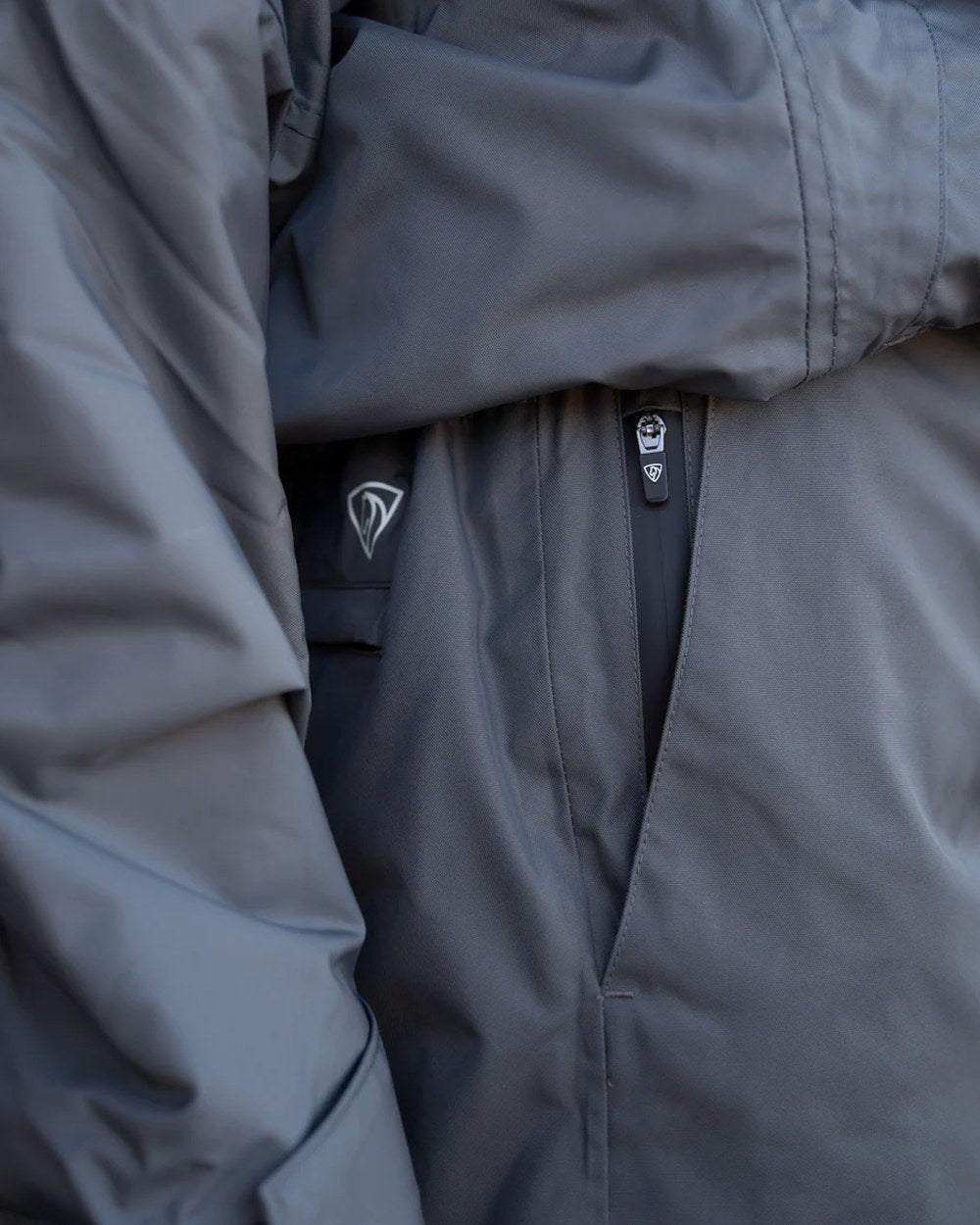 Charcoal coloured Equidry Mens Fleece Lined Waterproof Trousers on outdoor background 