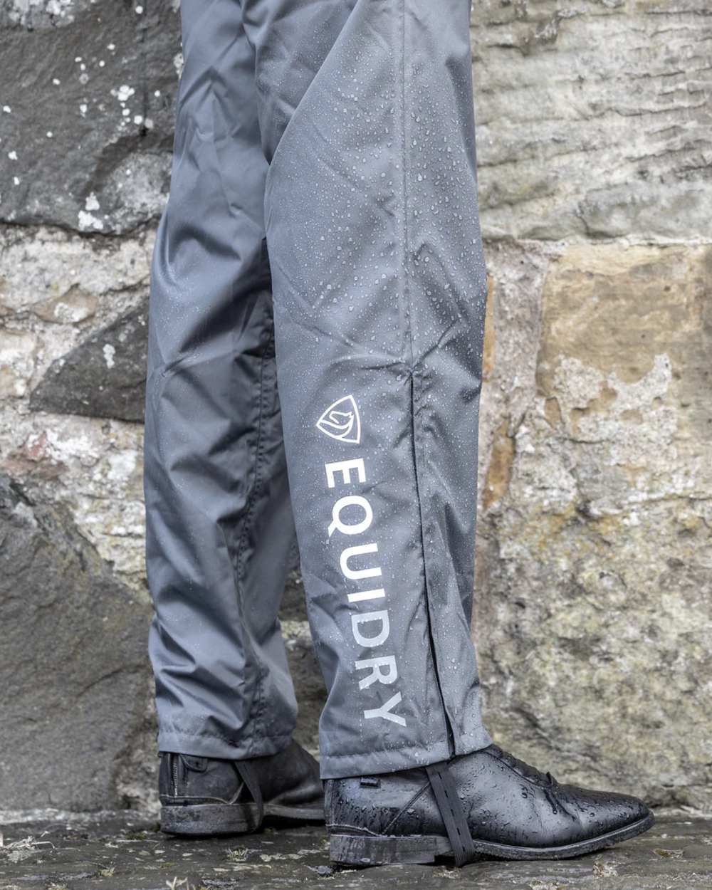 Charcoal coloured Equidry Mens Fleece Lined Waterproof Trousers on outdoor background 