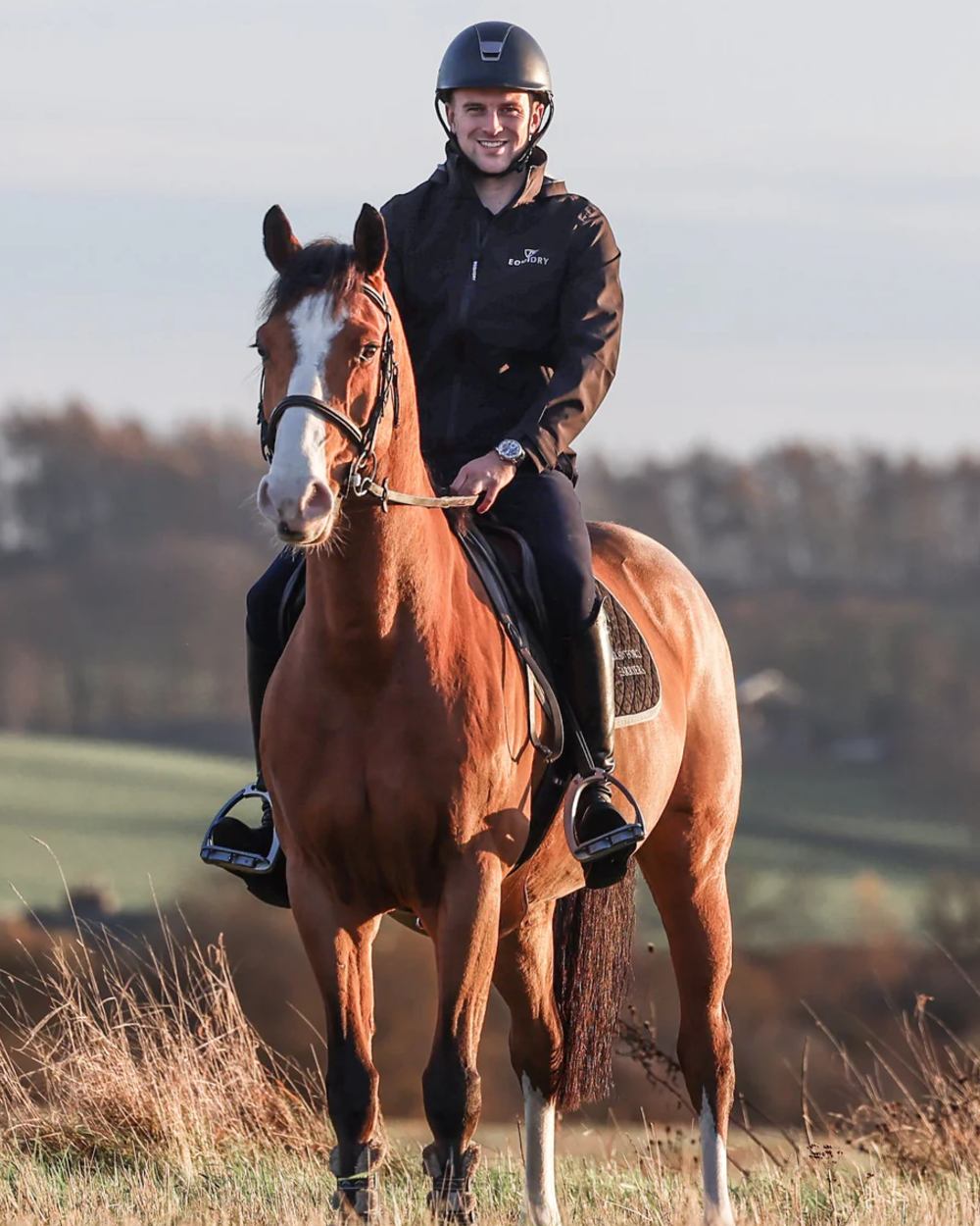 Black coloured Equidry Mens Nimbus Pack Away Jacket With Stowaway Hood on outdoor background 