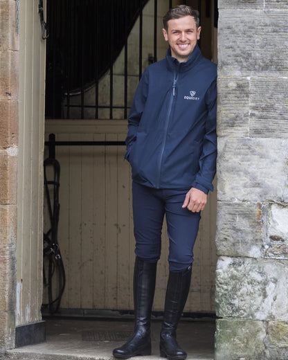 Navy coloured Equidry Mens Nimbus Pack Away Jacket With Stowaway Hood on outdoor background 