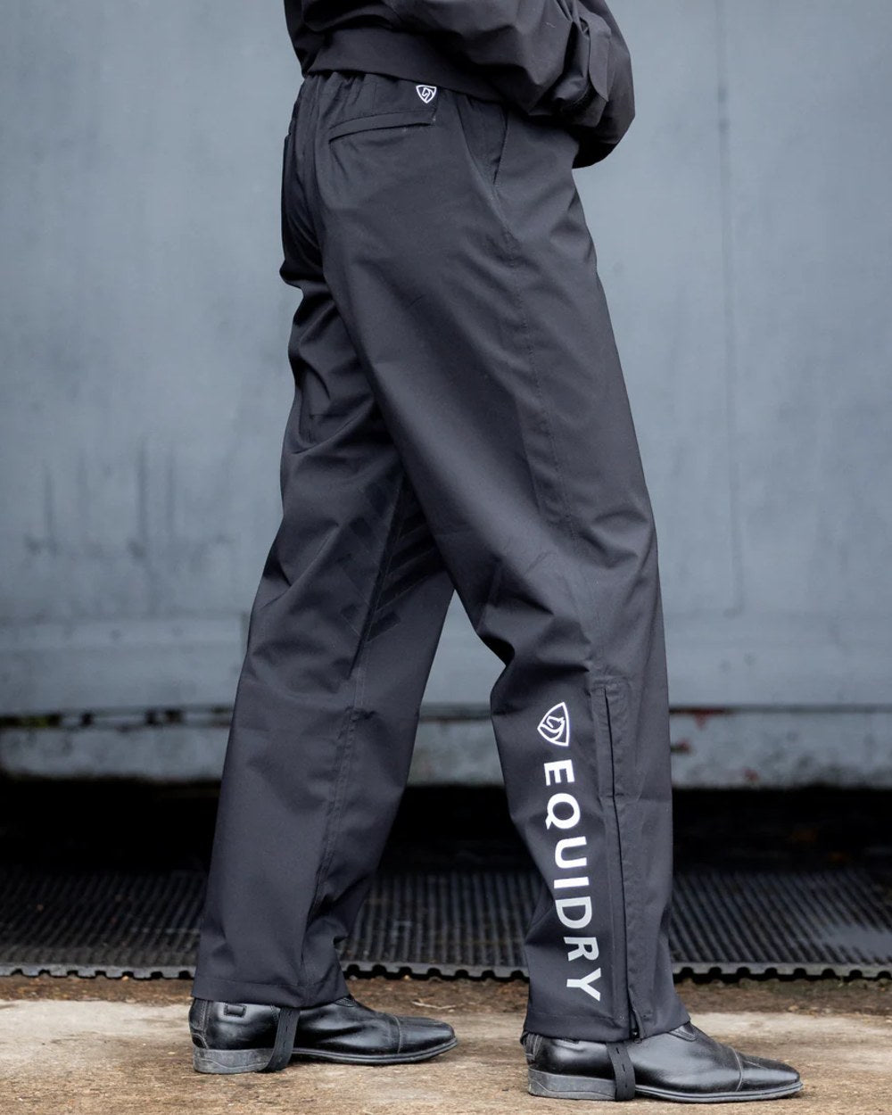 Black coloured Equidry Mens Unlined Waterproof Trousers on outdoor background 