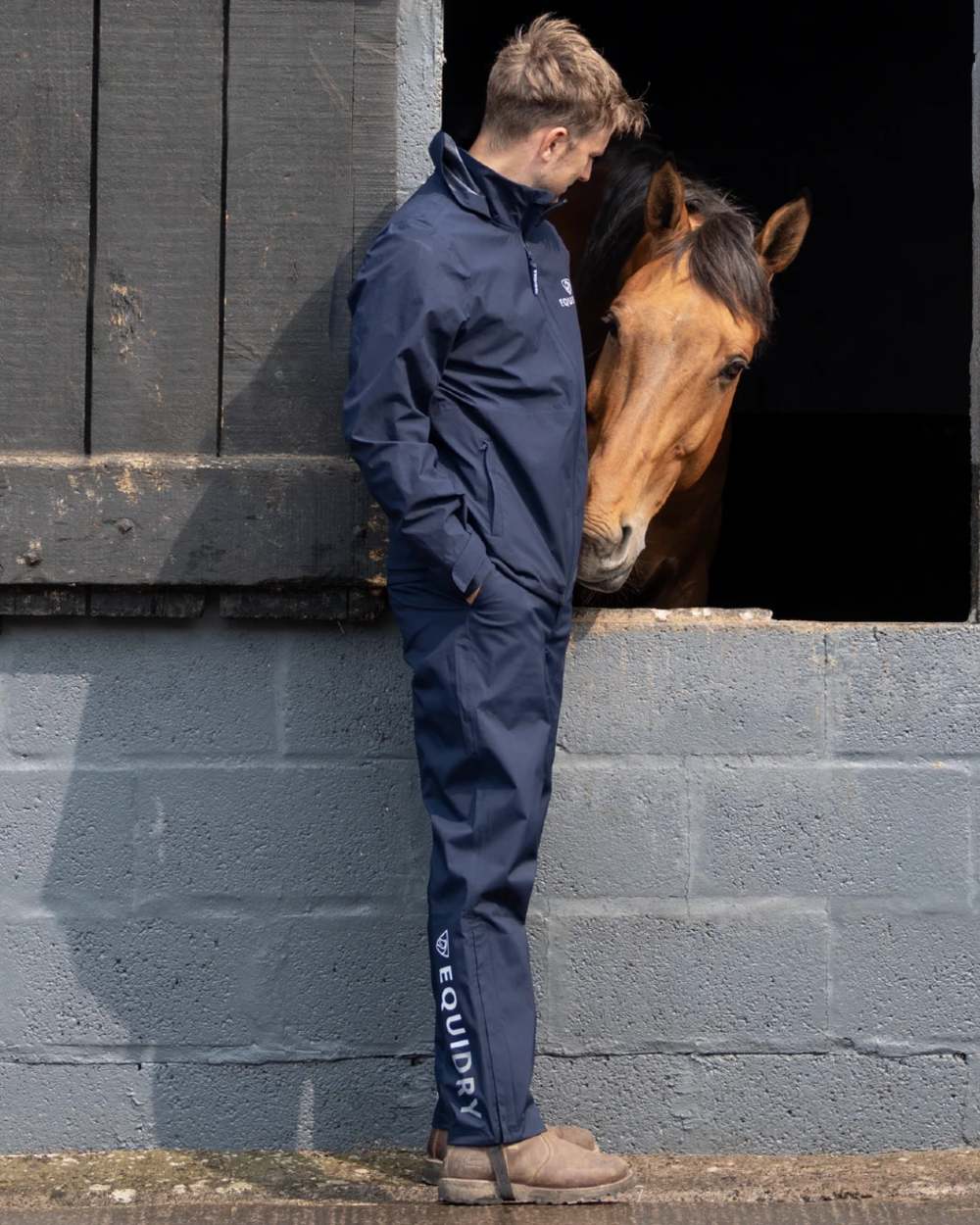 Navy coloured Equidry Mens Unlined Waterproof Trousers on outdoor background 