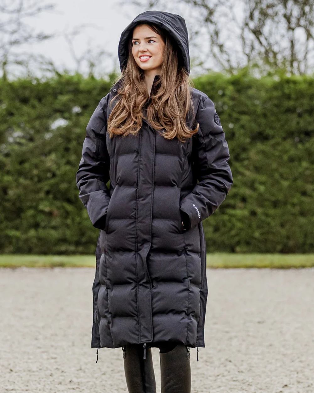 Black coloured Equidry Thora Waterproof Riding Puffer Coat With Hood on outdoor background 