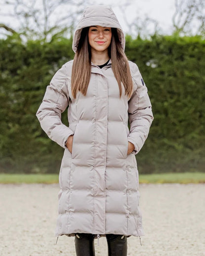 Taupe coloured Equidry Thora Waterproof Riding Puffer Coat With Hood on outdoor background 