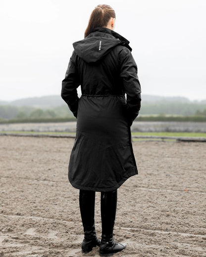 Black Coloured Equidry Womens Bronte Riding Coat With Removable Hood on outdoor background 