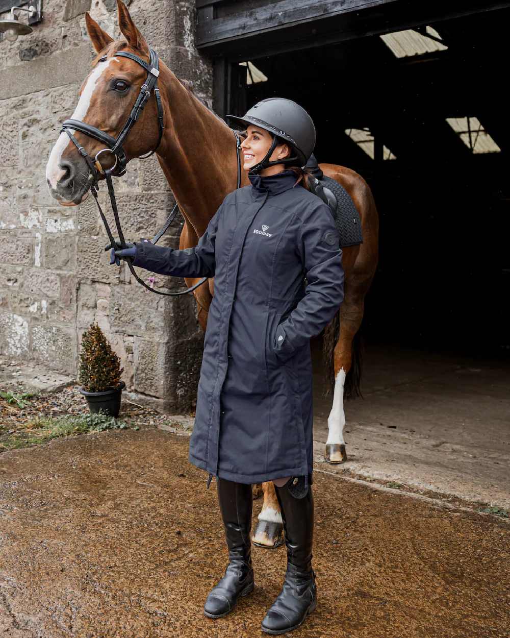 Navy Coloured Equidry Womens Bronte Riding Coat With Removable Hood on outdoor background 