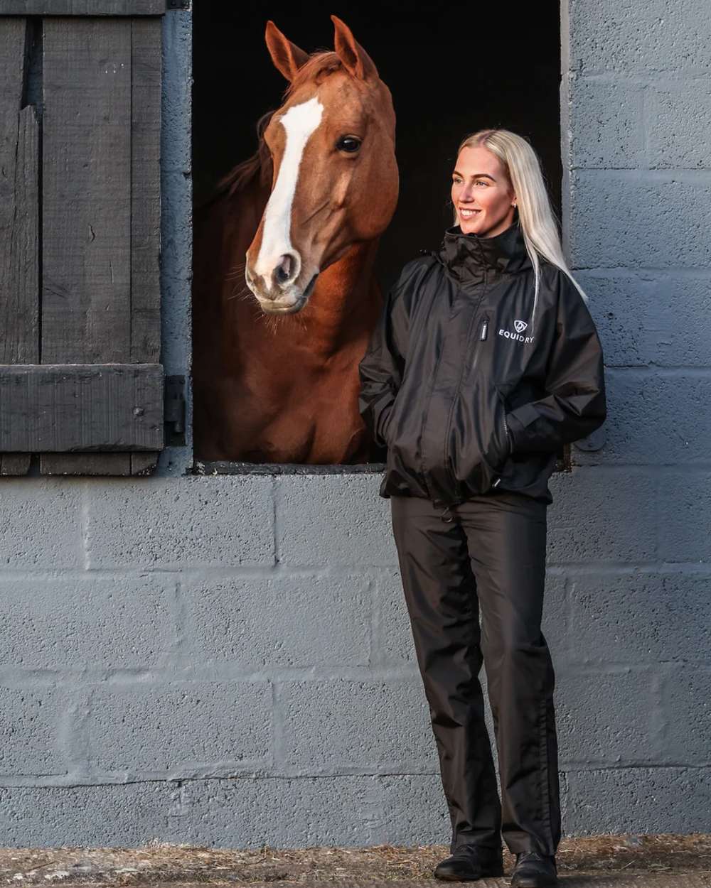 Black coloured Equidry Womens Equimac Shortie With Stowaway Hood on outdoor background 