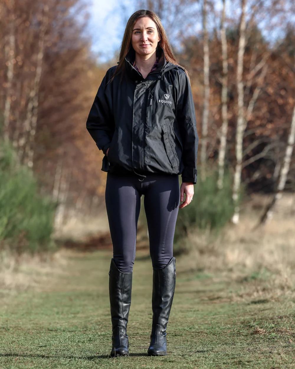 Black coloured Equidry Womens Equimac Shortie With Stowaway Hood on outdoor background 