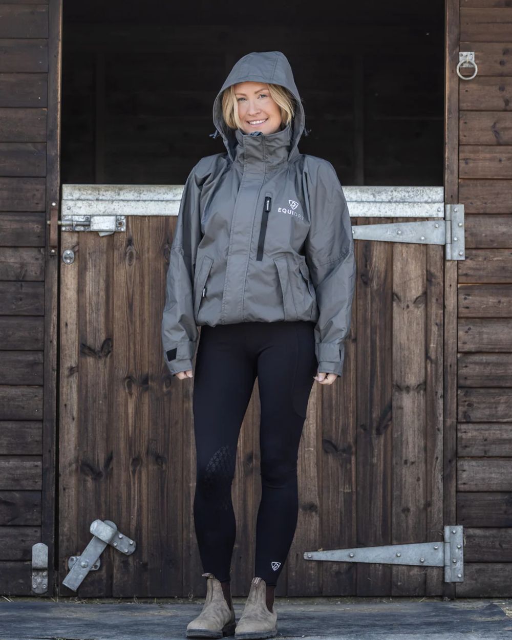 Charcoal coloured Equidry Womens Equimac Shortie With Stowaway Hood on outdoor background 