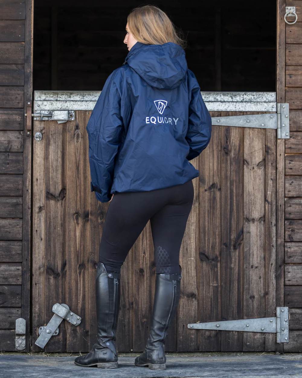 Navy coloured Equidry Womens Equimac Shortie With Stowaway Hood on outdoor background 