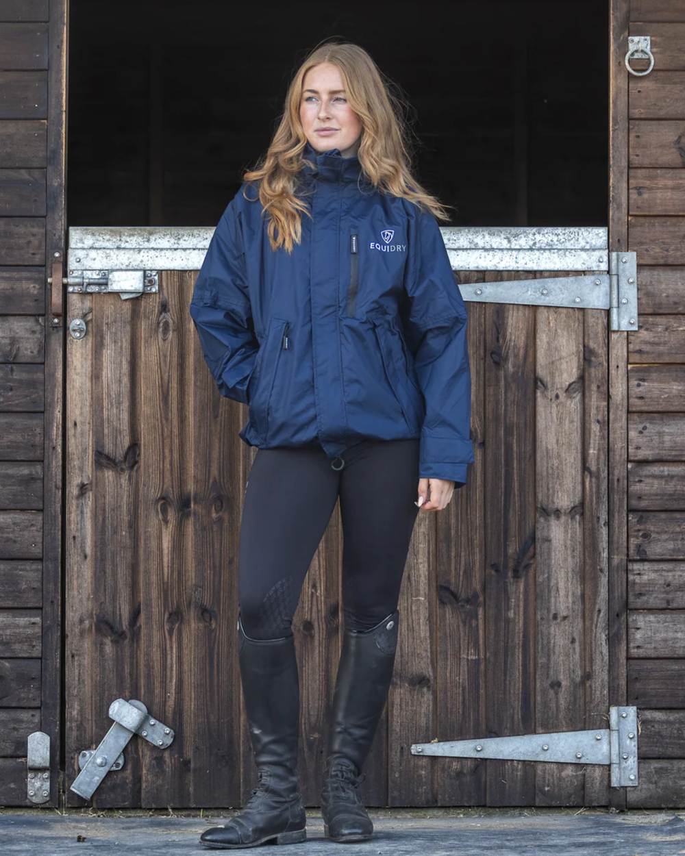Navy coloured Equidry Womens Equimac Shortie With Stowaway Hood on outdoor background 