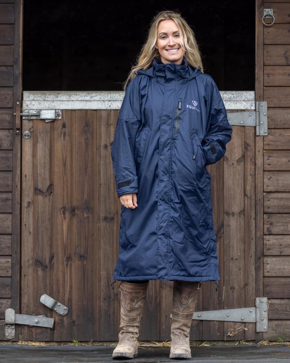 Navy coloured Equidry Womens Pro Ride Evolution Thin Fleece Coat With Stowaway Hood on outdoor background 