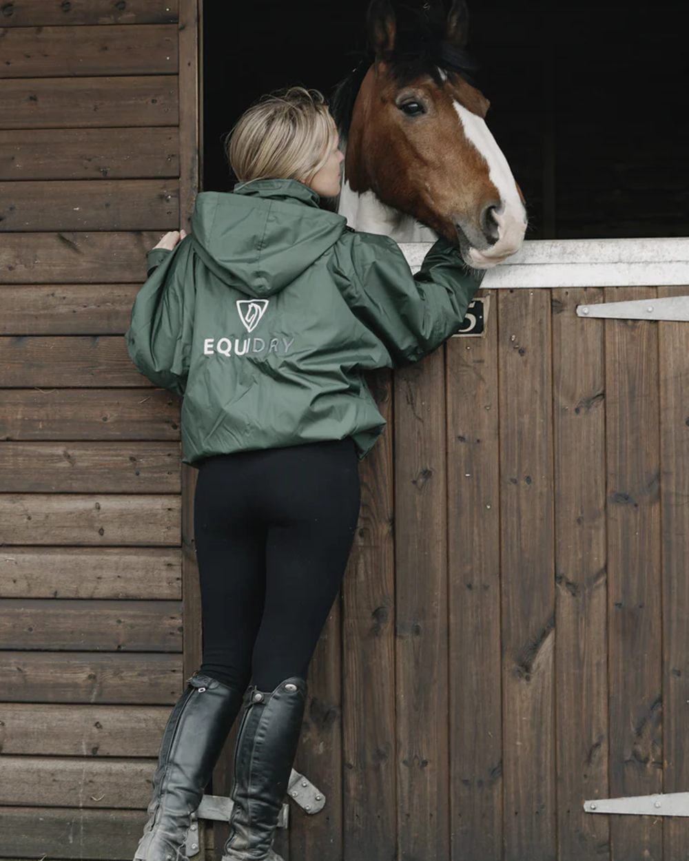 Black Forest Green coloured Equidry Womens Shortie Thin Fleece Jacket With Stowaway Hood on outdoor background 