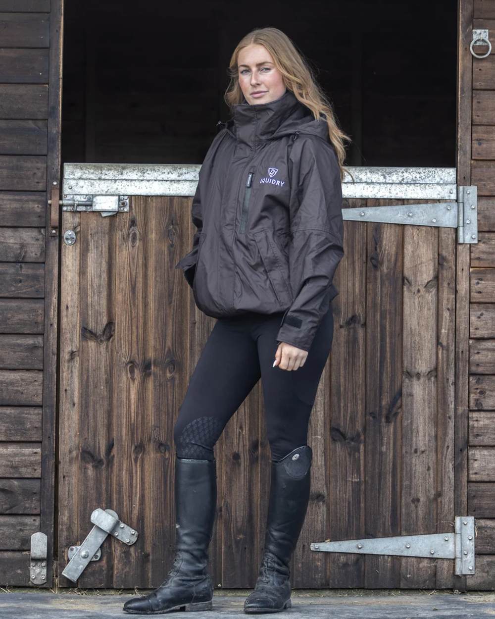 Rich Brown Equidry Womens Shortie Thin Fleece Jacket With Stowaway Hood on outdoor background 