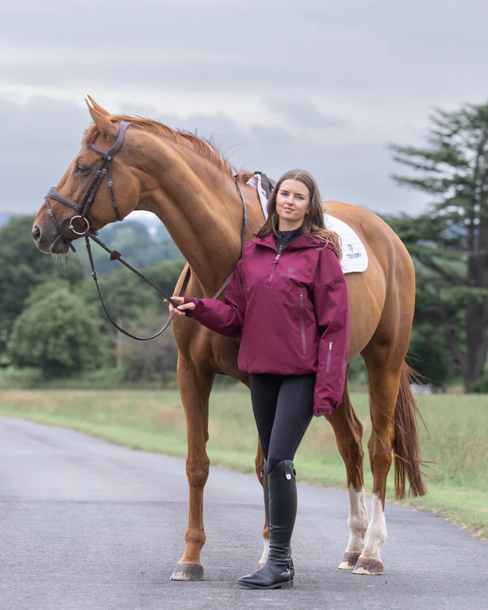 Plum coloured Equidry Womens Storm Smock With Velour Lining on outdoor background 