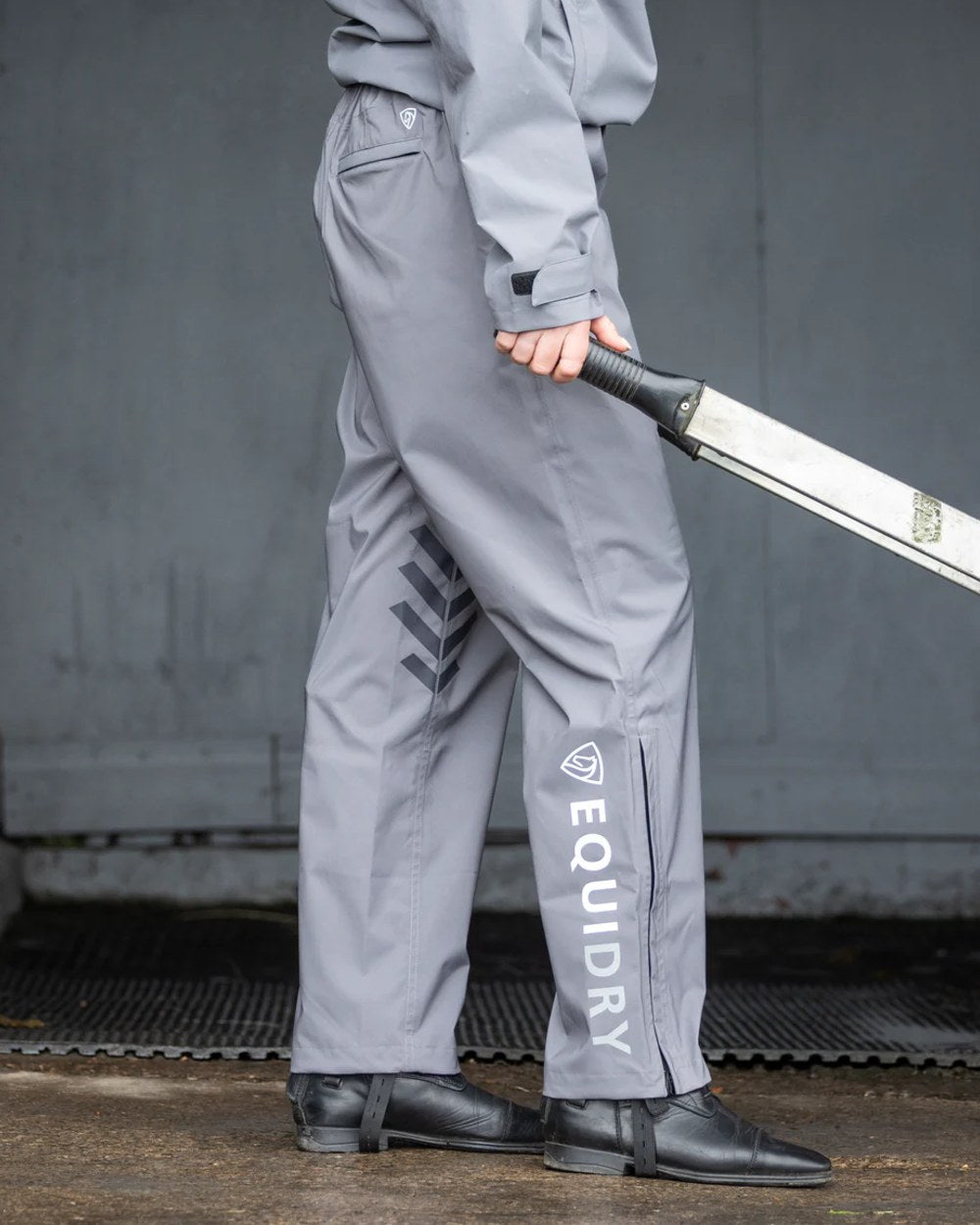 Charcoal coloured Equidry Womens Unlined Waterproof Trousers on outdoor background 