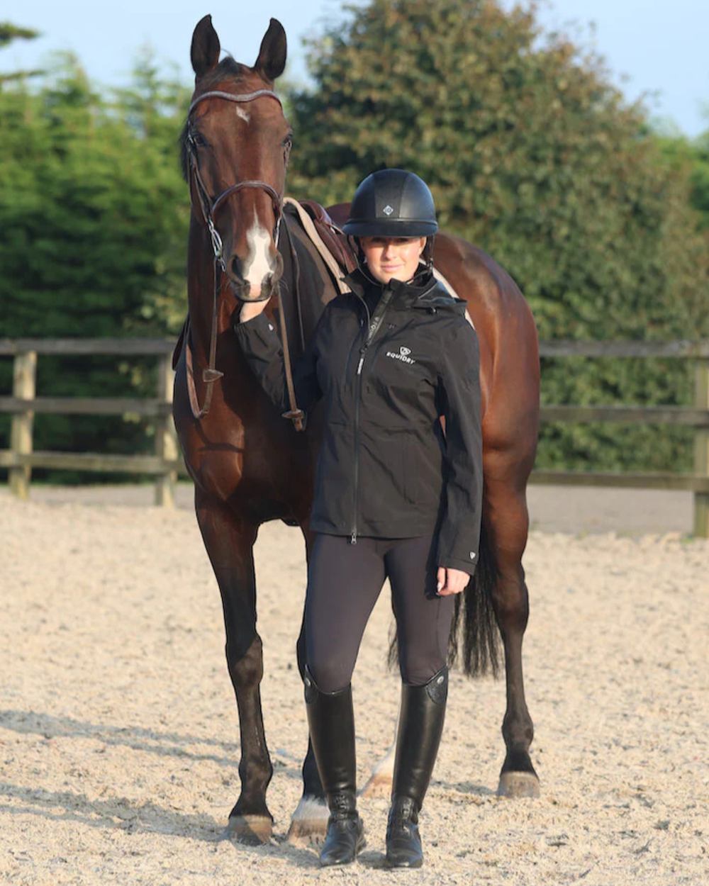 Black coloured Equidry Womens Varsha Jacket with Stowaway Hood on sand background 