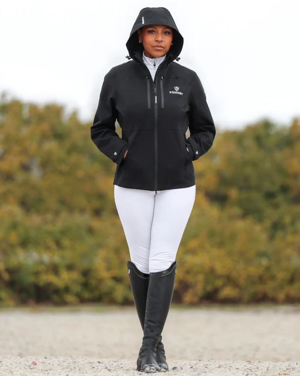 Black coloured Equidry Womens Varsha Jacket with Stowaway Hood on sand background 