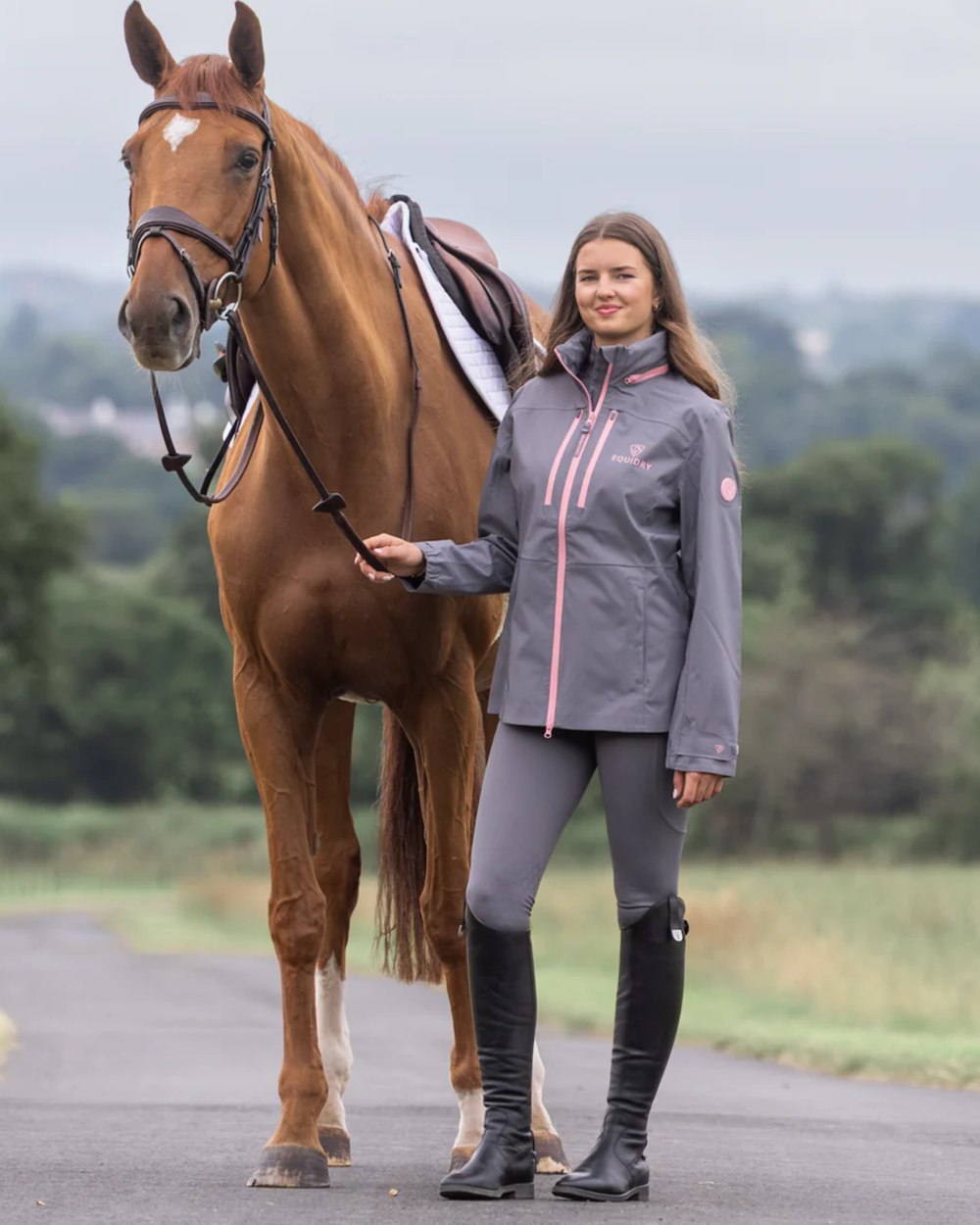 Charcoal Pink coloured Equidry Womens Varsha Jacket with Stowaway Hood on street background 