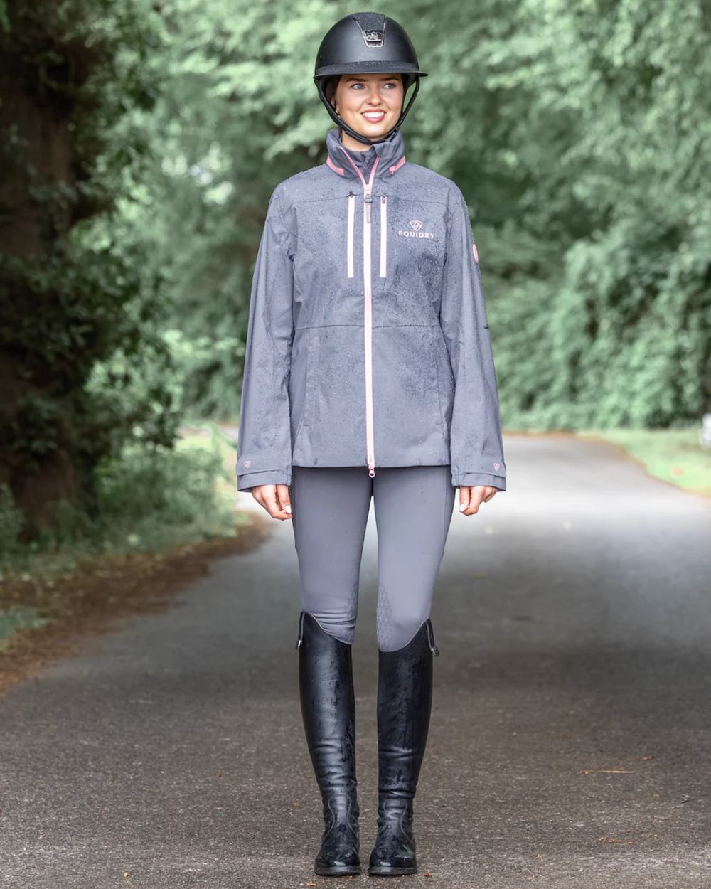 Charcoal Pink coloured Equidry Womens Varsha Jacket with Stowaway Hood on street background 