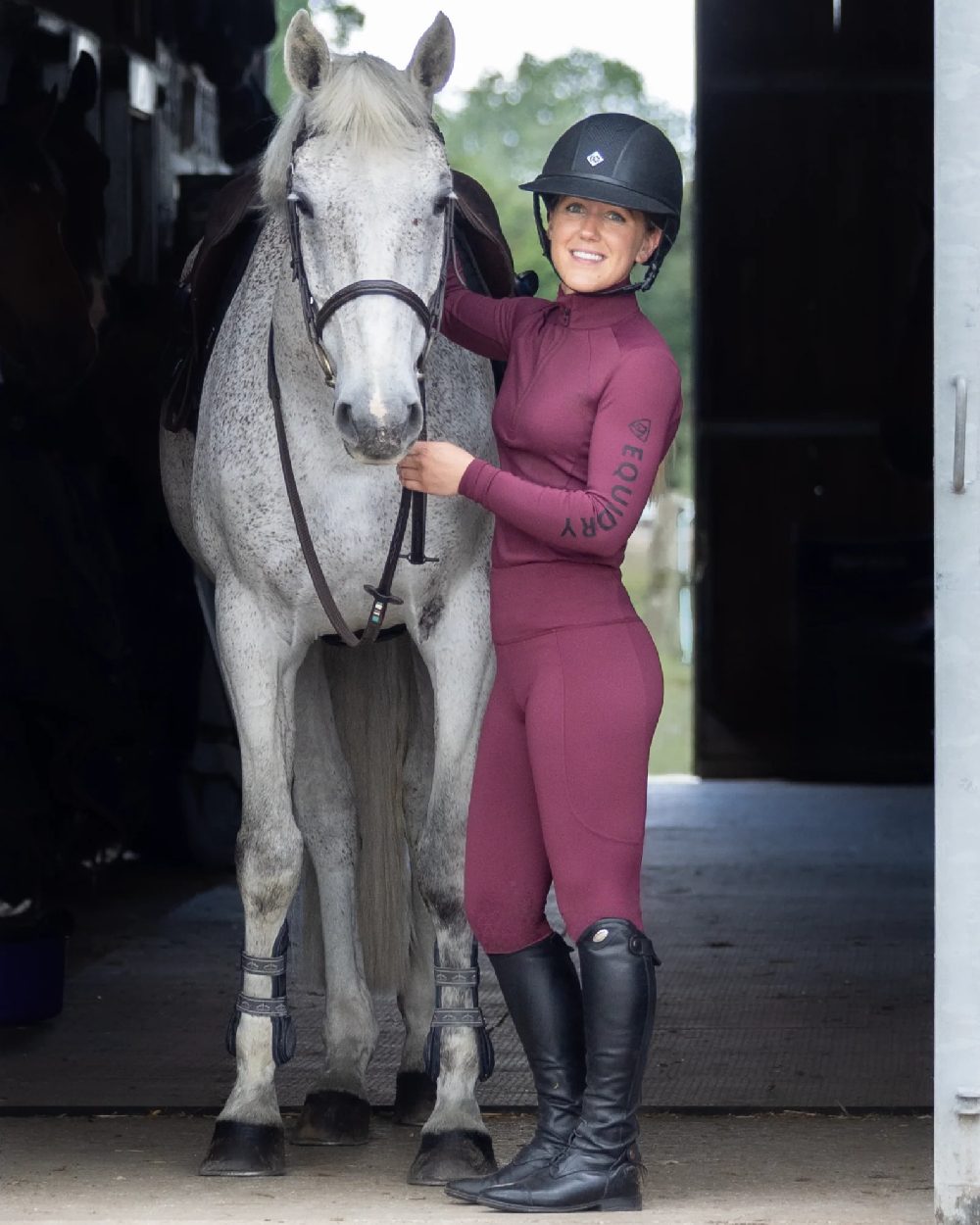 Plum Black Coloured Equidry Womens Water Repellent Base Layer on stable background 