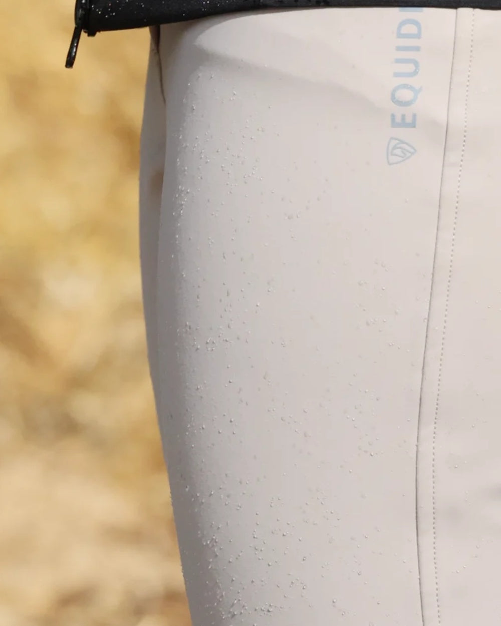 Beige coloured Equidry Womens Waterproof Riding Breeches on outdoor background 