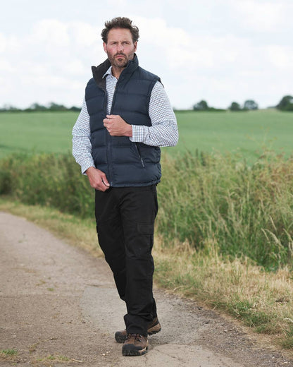 Navy coloured Fort Downham Bodywarmer on blurry green background 