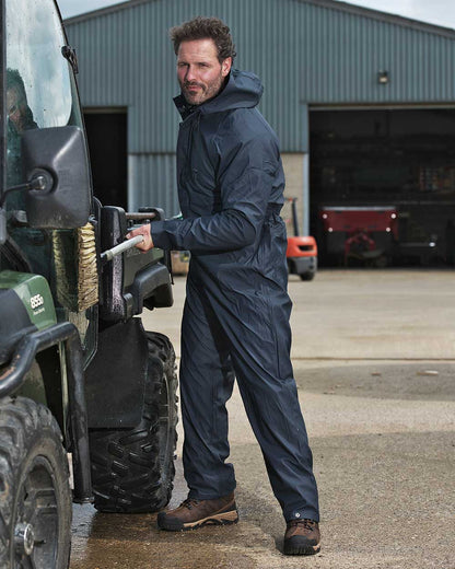 Navy coloured Fort Fortex Flex Coverall on work shed background 