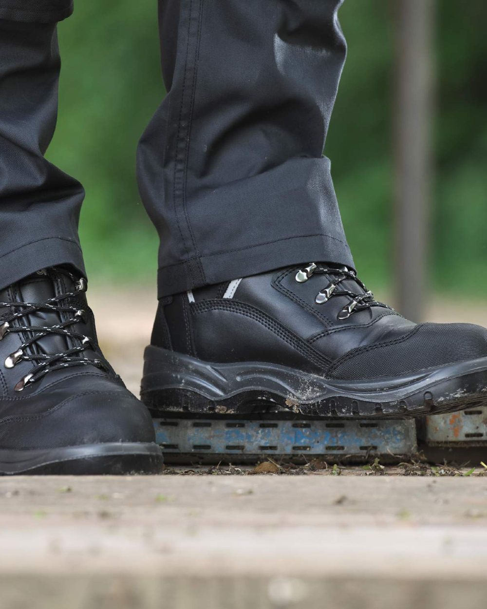 Black coloured Fort Knox Safety Boots on blurry background 