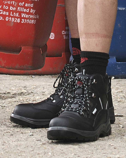 Black coloured Fort Knox Safety Boots on red background 