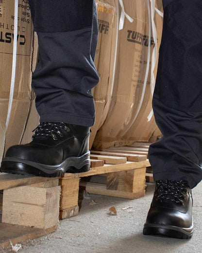 Black coloured Fort Toledo Safety Boots on brown background 