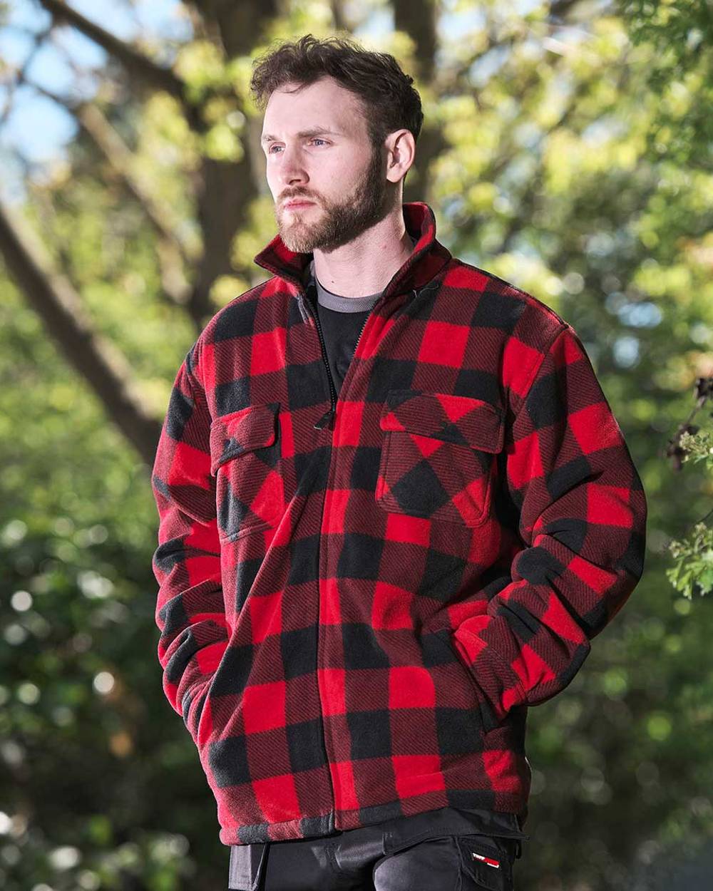 Red coloured Fort Portman Fleece Jacket on green background 