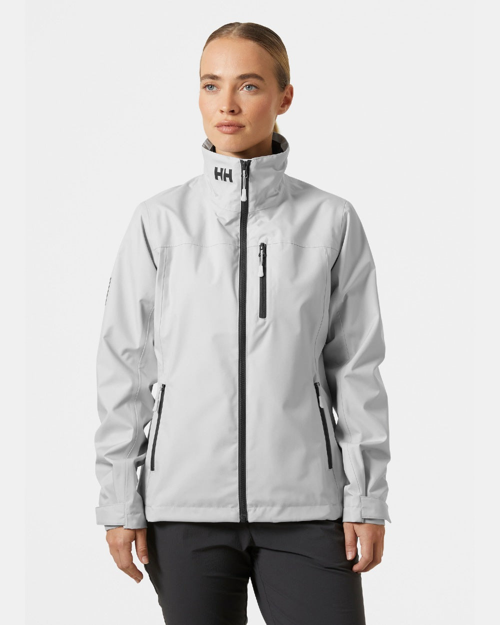 Grey Fog coloured Helly Hansen Womens Crew Sailing Jacket 2.0 on grey background 