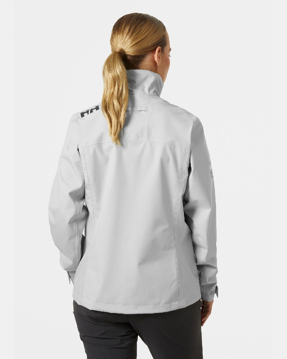 Grey Fog coloured Helly Hansen Womens Crew Sailing Jacket 2.0 on grey background 