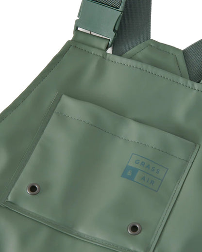 Khaki coloured Grass &amp; Air Childrens Rainster Waterproof Dungaree on white background  