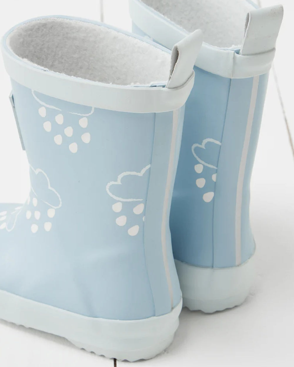 Ice Blue coloured Grass &amp; Air Childrens Colour-Revealing Wellies on wooden table background 