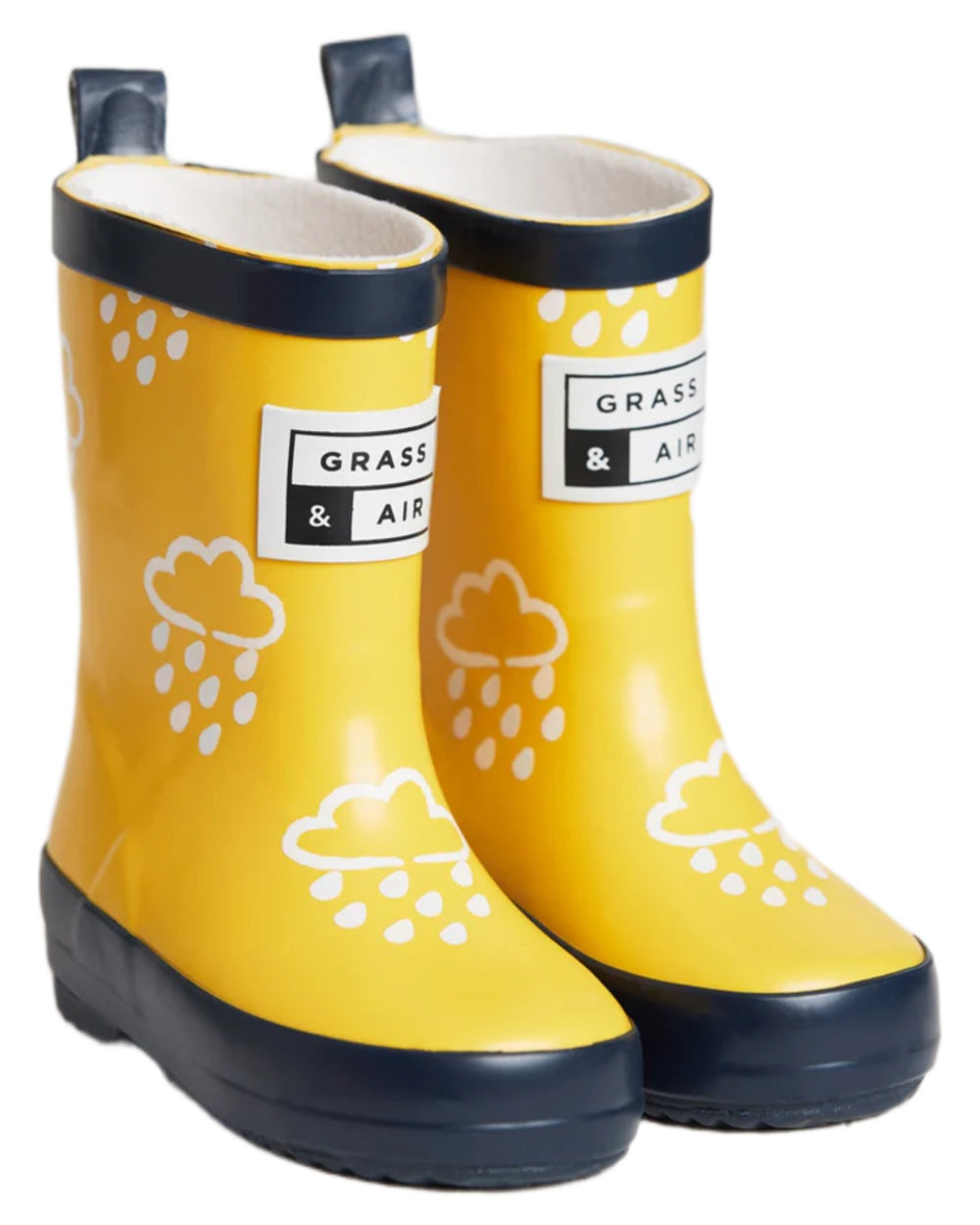 Yellow coloured Grass &amp; Air Childrens Colour-Revealing Wellies on white table background 