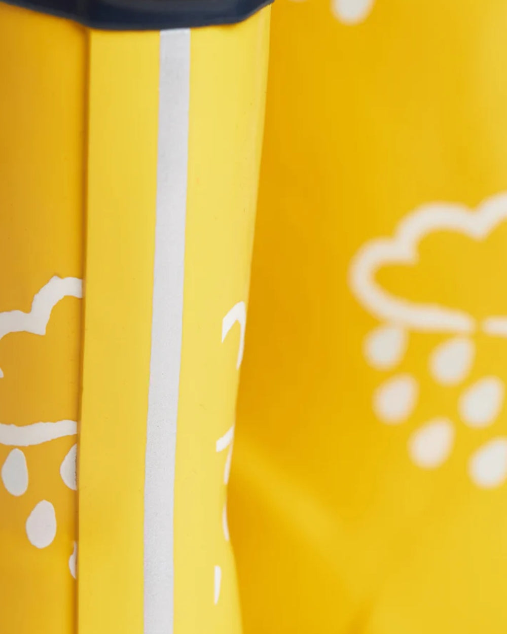 Yellow coloured Grass &amp; Air Childrens Colour-Revealing Wellies on white table background 