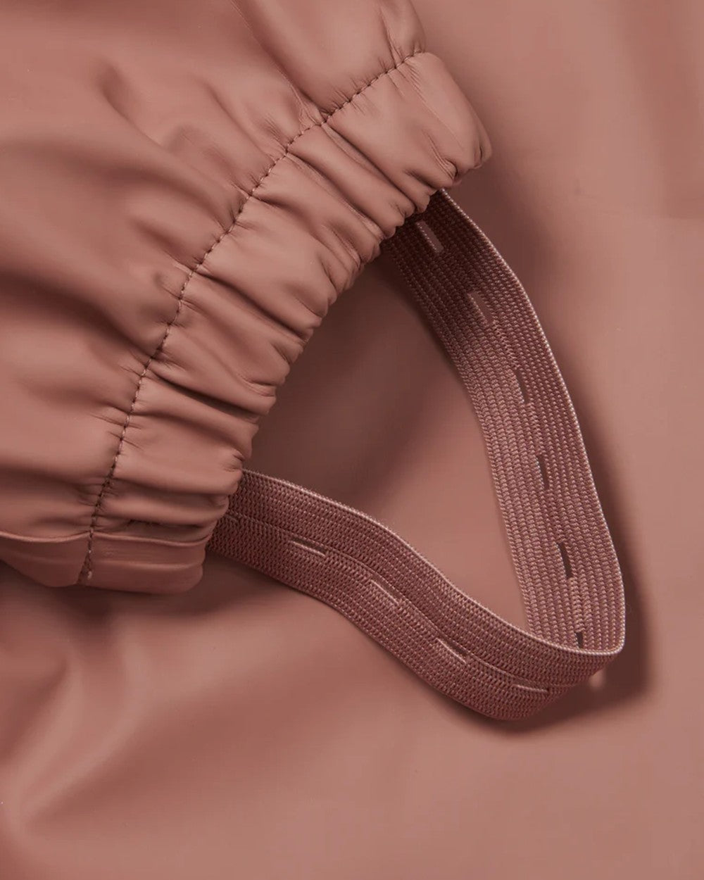 Rose coloured Grass &amp; Air Childrens Puddle Suit on white background 