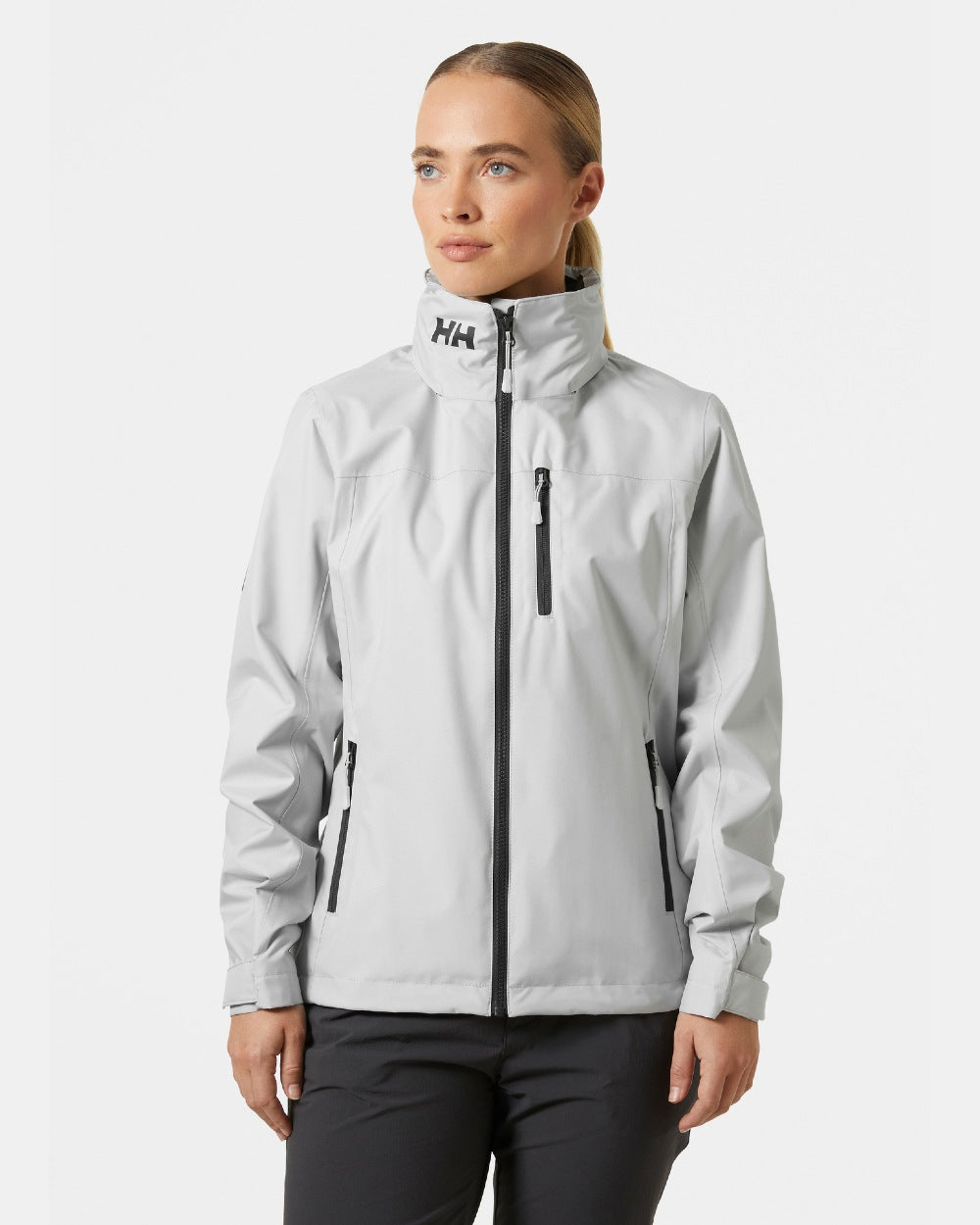 Grey Fog coloured Helly Hansen womens crew hooded sailing jacket 2.0 on grey background 