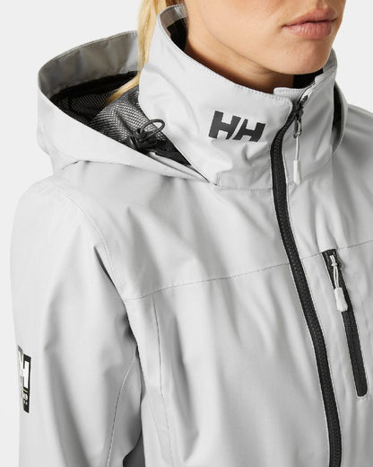Grey Fog coloured Helly Hansen womens crew hooded sailing jacket 2.0 on grey background 