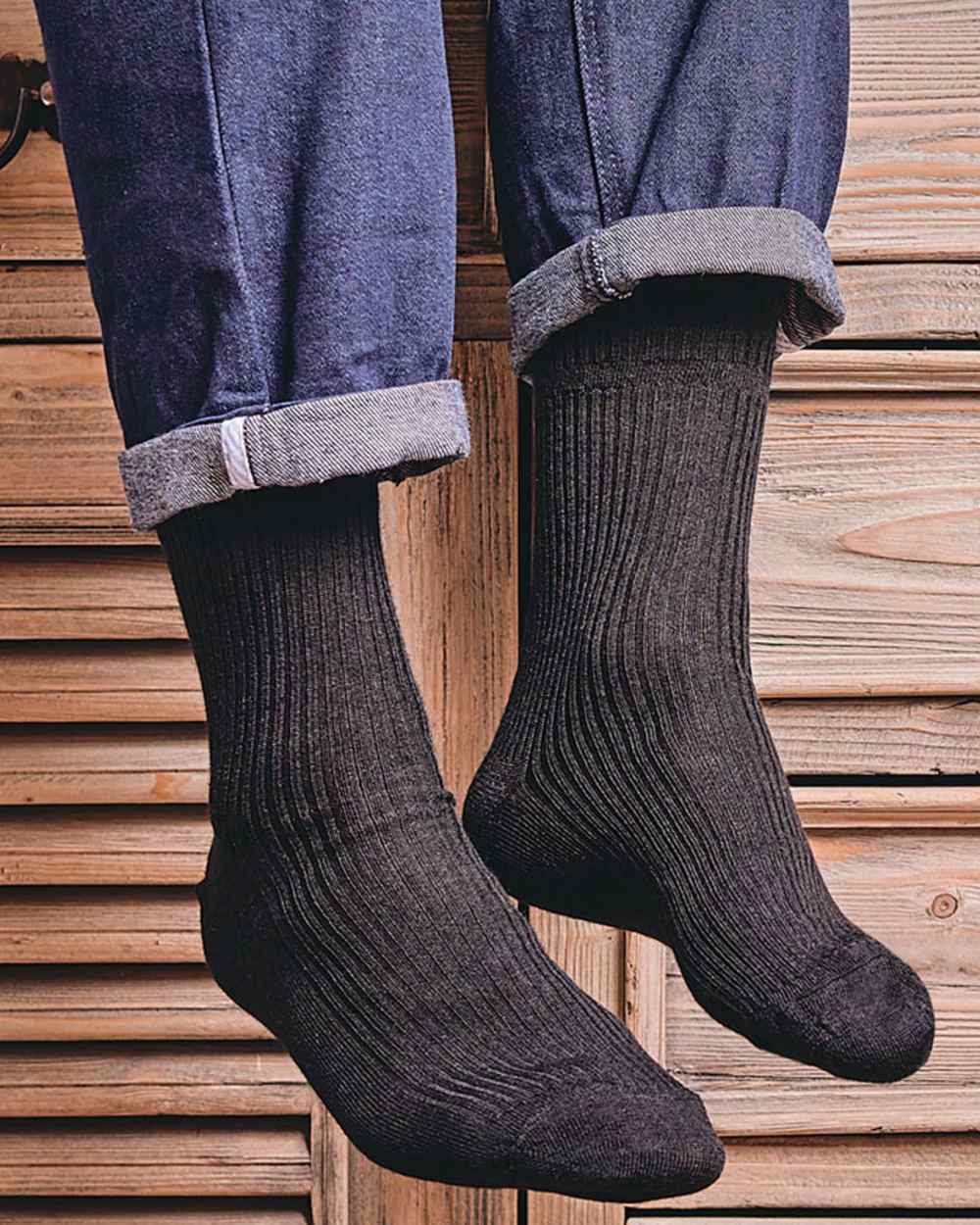 Black coloured HJ Hall Extra Wide Soft Top Sock Sanitised Wool on indoor background 